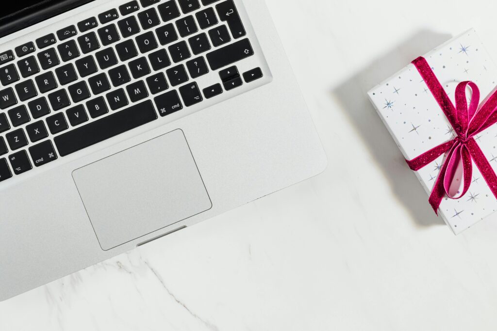 Gift box placed on a desk next to a laptop, representing corporate gifting in a professional setting.