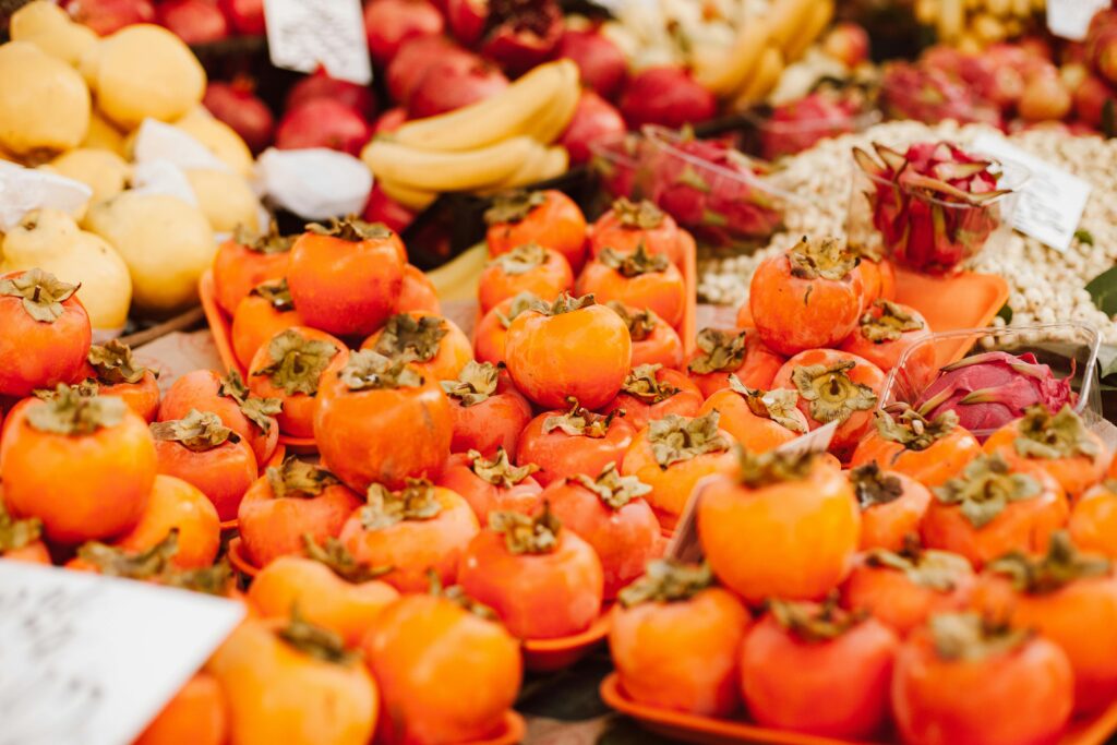 Premium Korean persimmons and seasonal fruits arranged on a table